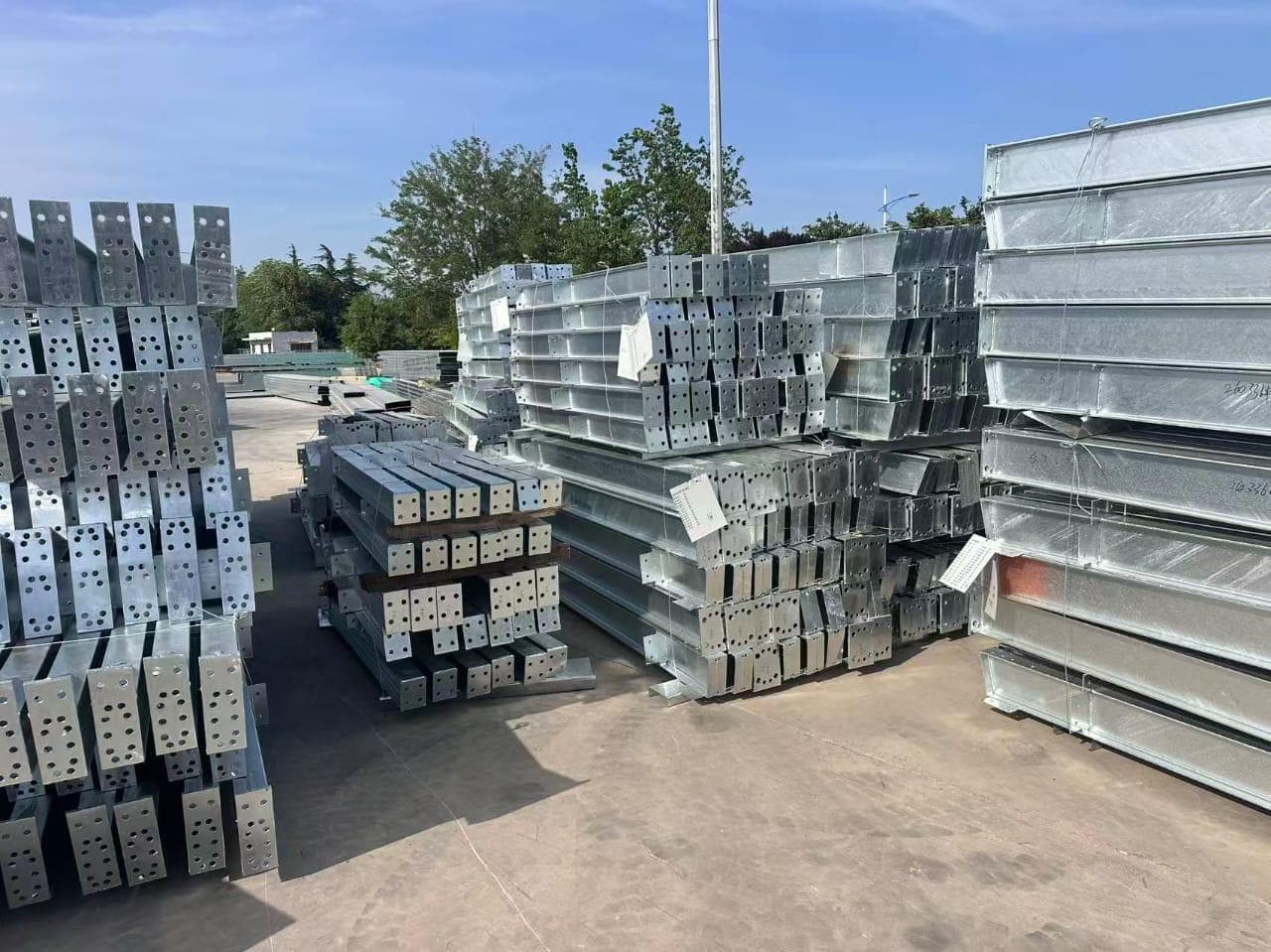 Drilled galvanized steel structural beams and brackets in an outdoor stockyard