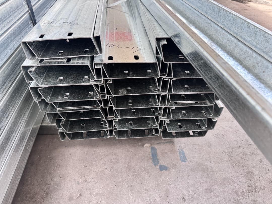 Close-up of stacked galvanized steel C-purlin channel ends