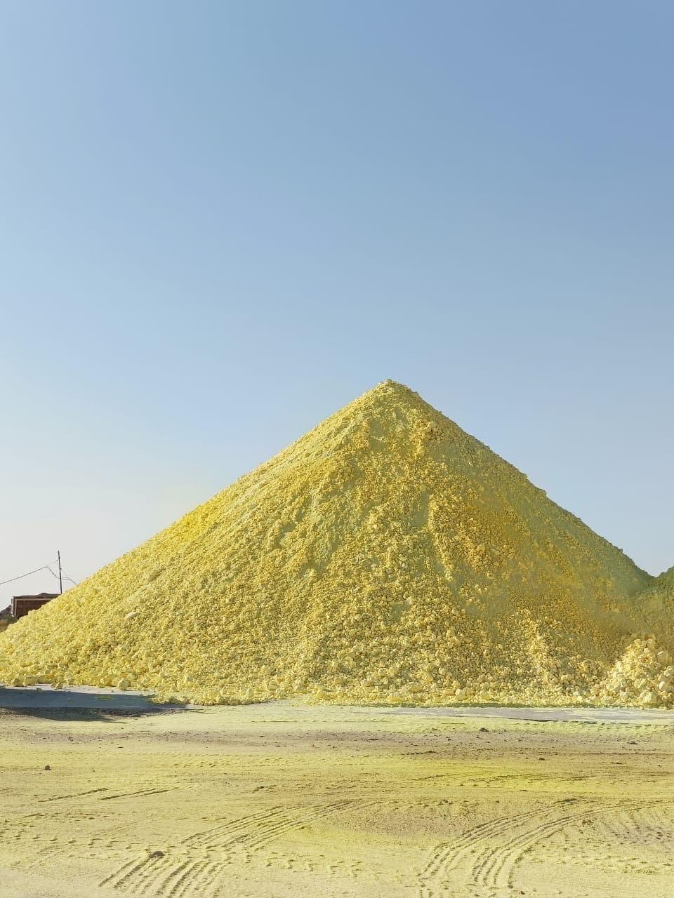 Bulk granular sulphur stockpile at an outdoor storage yard